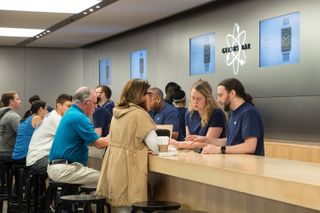 Apple mağazasının içindeki Genius Bar'daki insanlar.