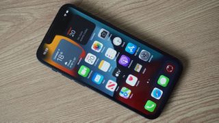 Ahşap bir yüzey üzerinde bir iPhone 13 mini