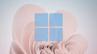 Windows'ta pano geçmişinin nasıl etkinleştirileceği hakkında bir makaleyi temsil eden mavi Windows 11 logosunun üst üste bindirildiği Windows 11 duvar kağıdı